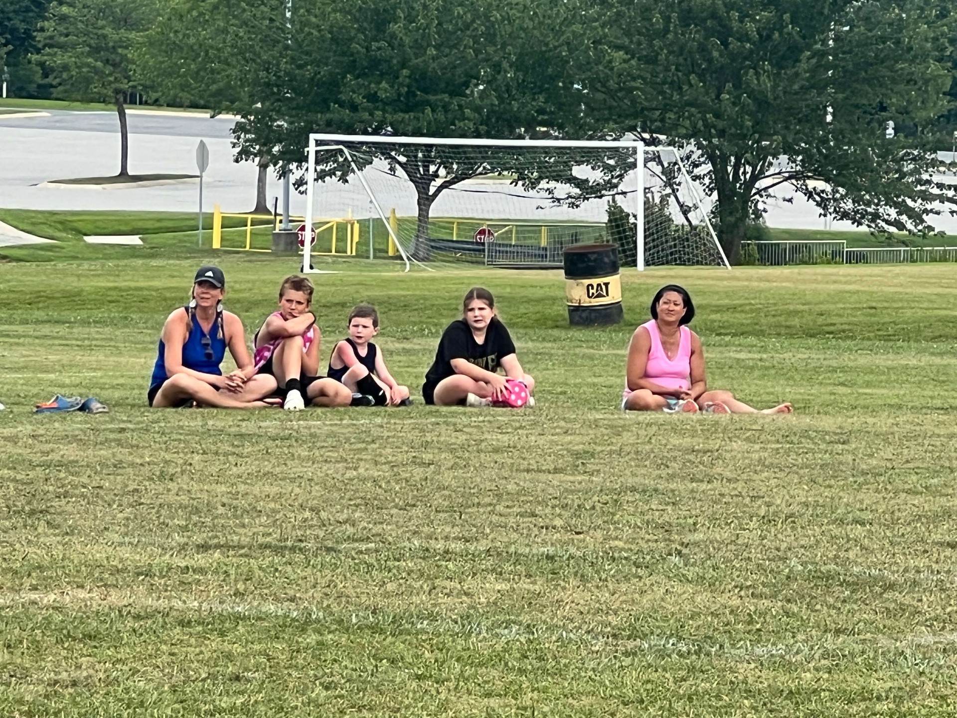 2025 — Family and kids relaxing on the grass watching games