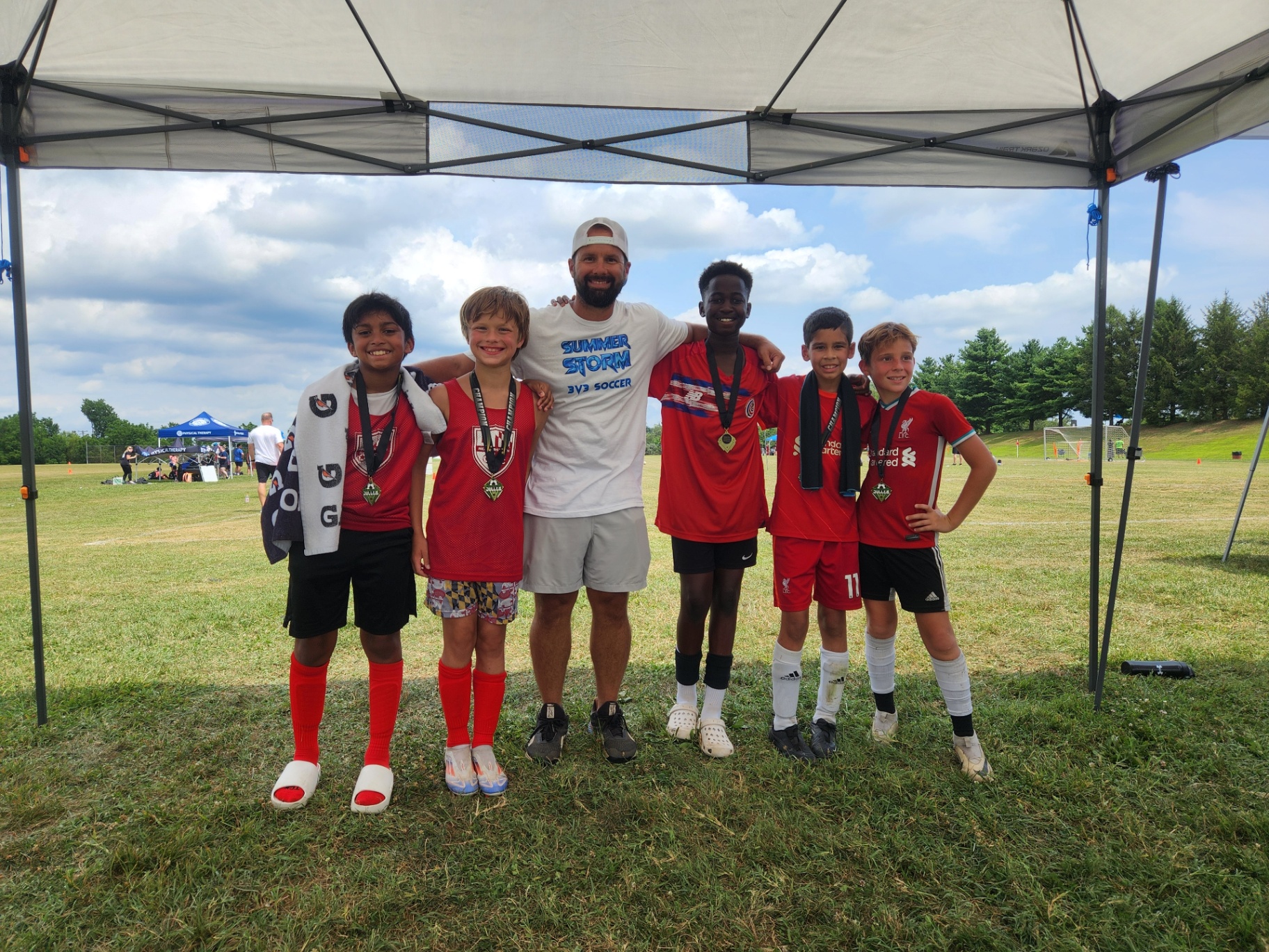 2025 — Red team and coach posing with championship medals