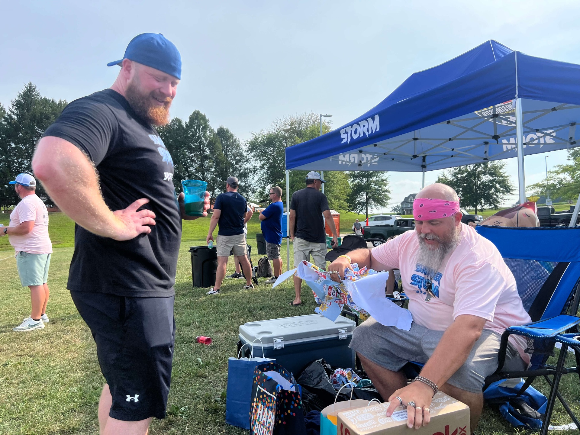 2025 — Coaches enjoying drinks and gifts at the Storm tent celebration