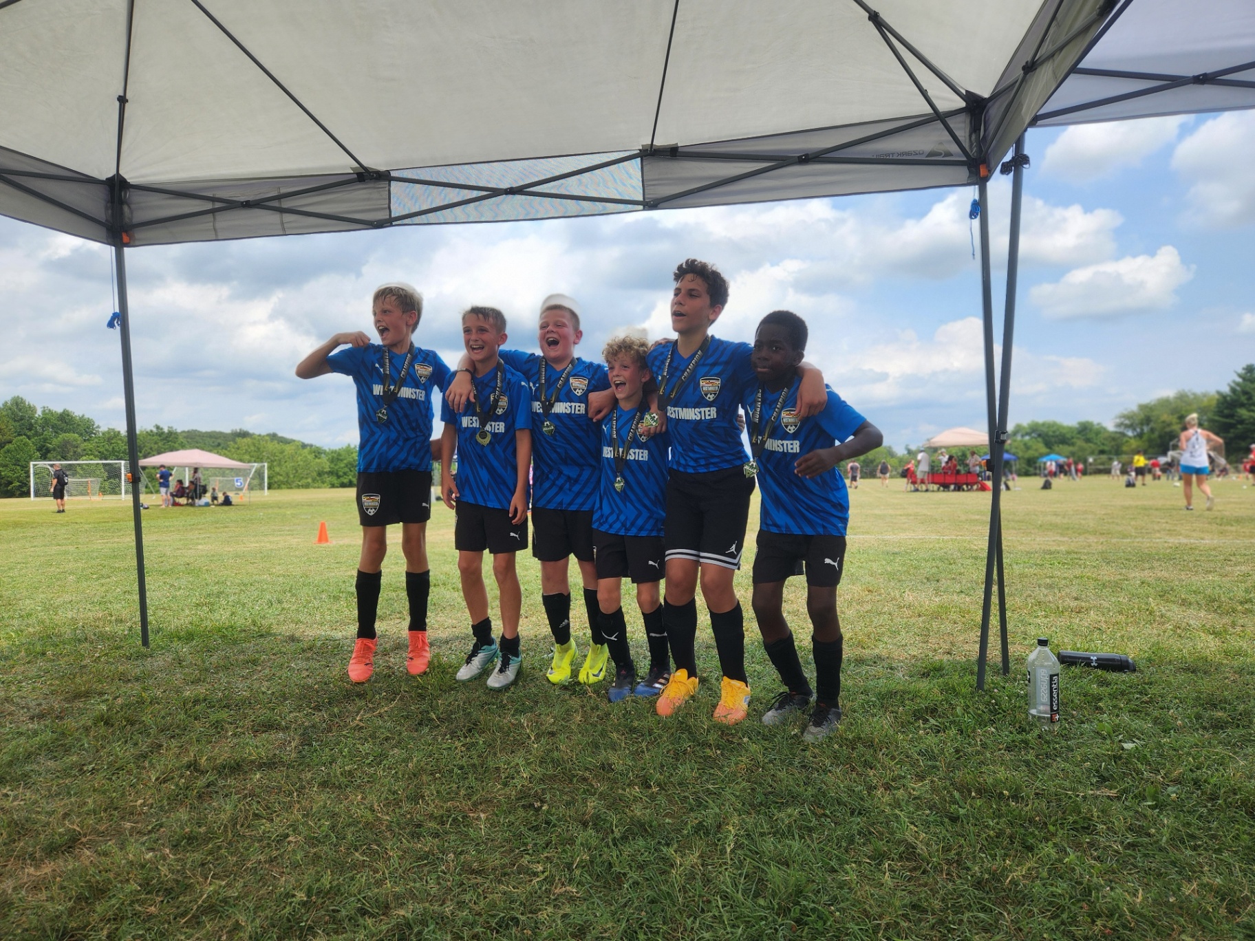 2025 — Westminster boys team in blue celebrating with championship medals