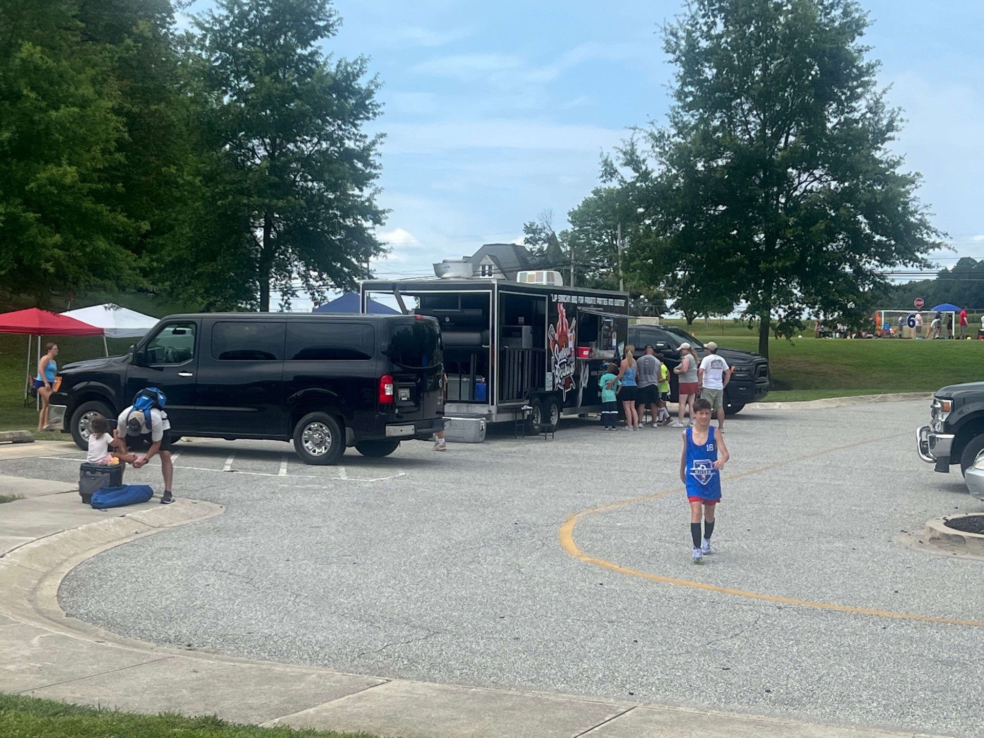 Food truck and player walking through the parking area