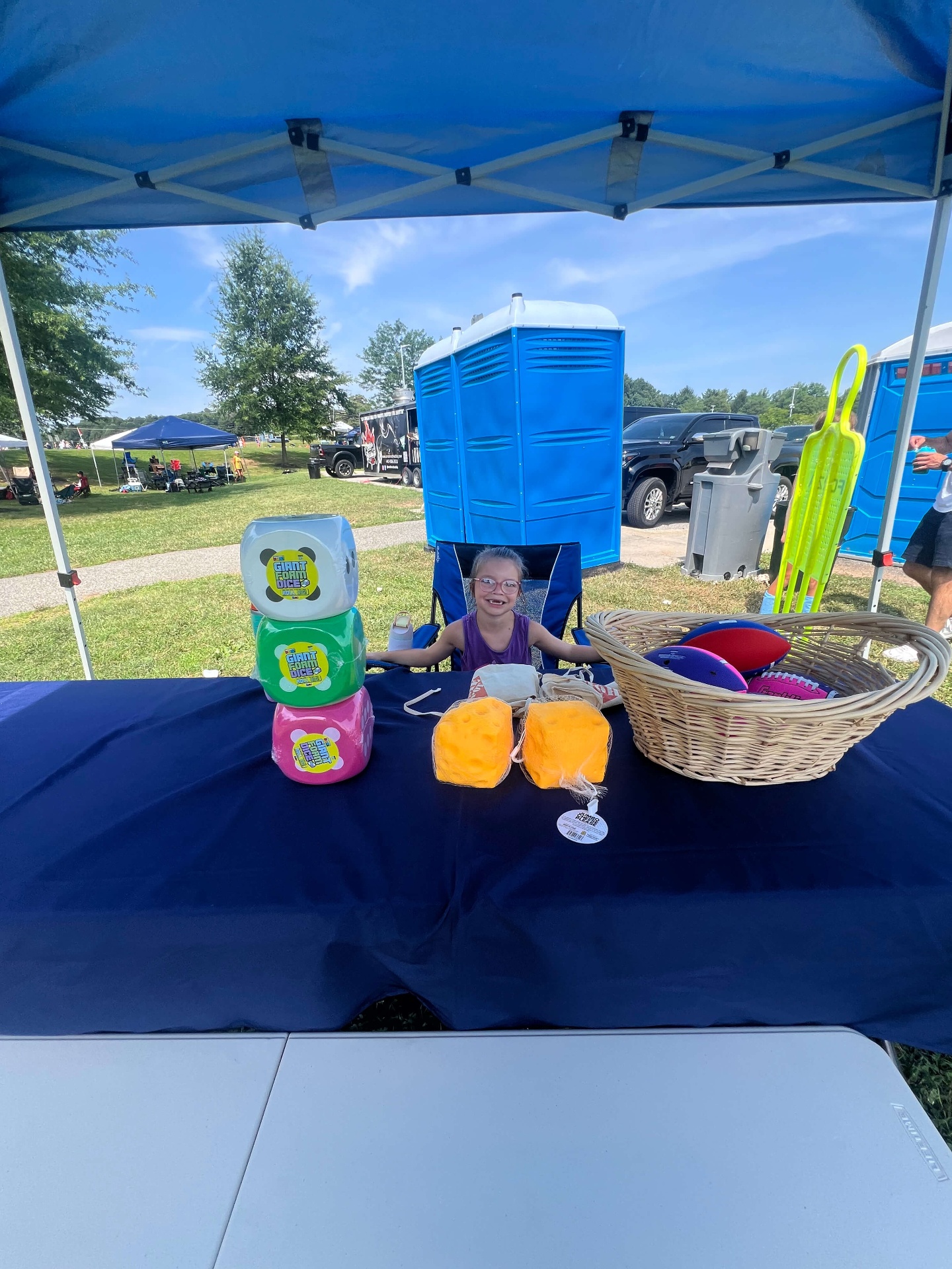 Kids' games table with giant foam dice and footballs