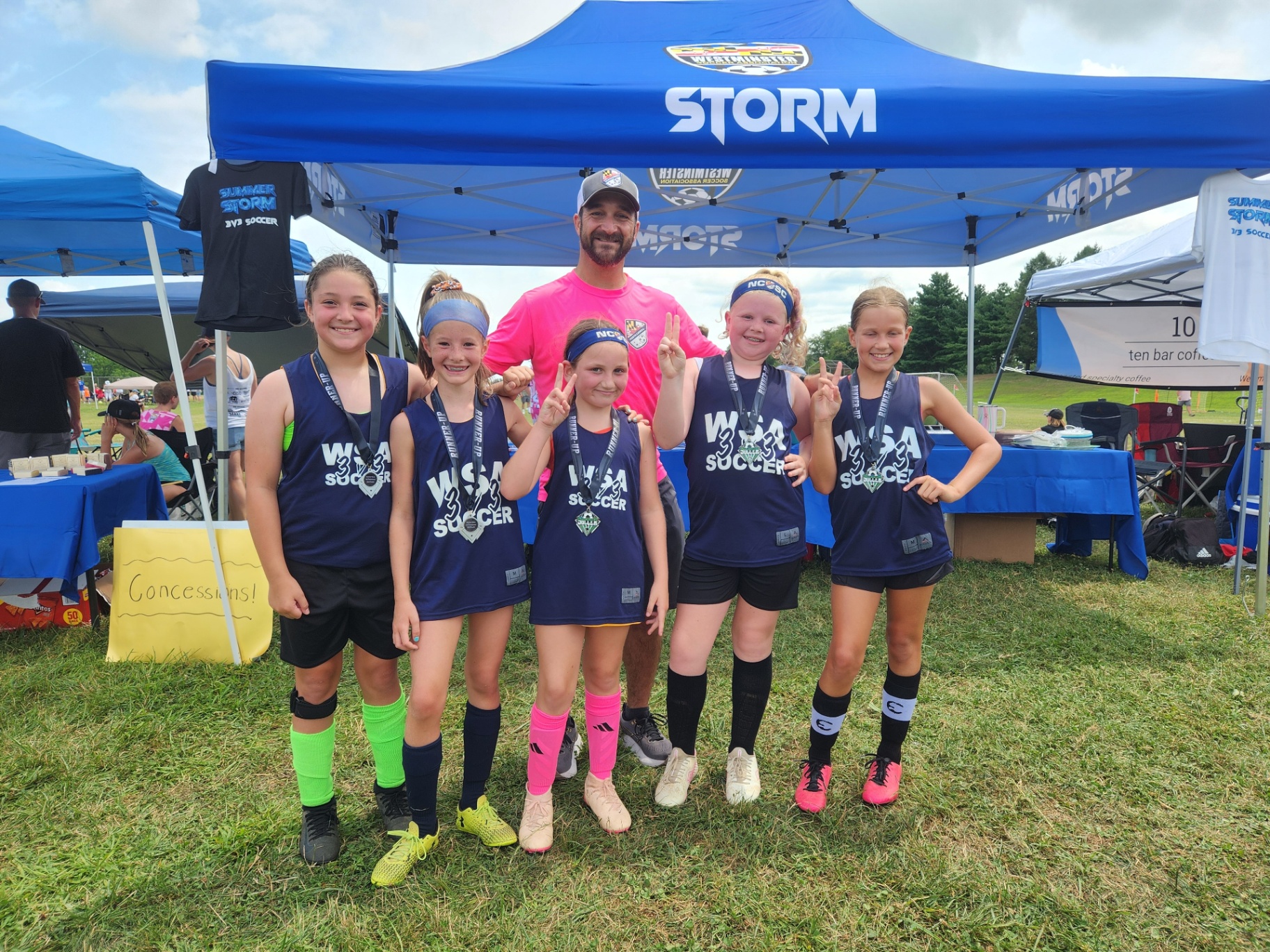 WSA girls team with runner-up medals under the Storm tent