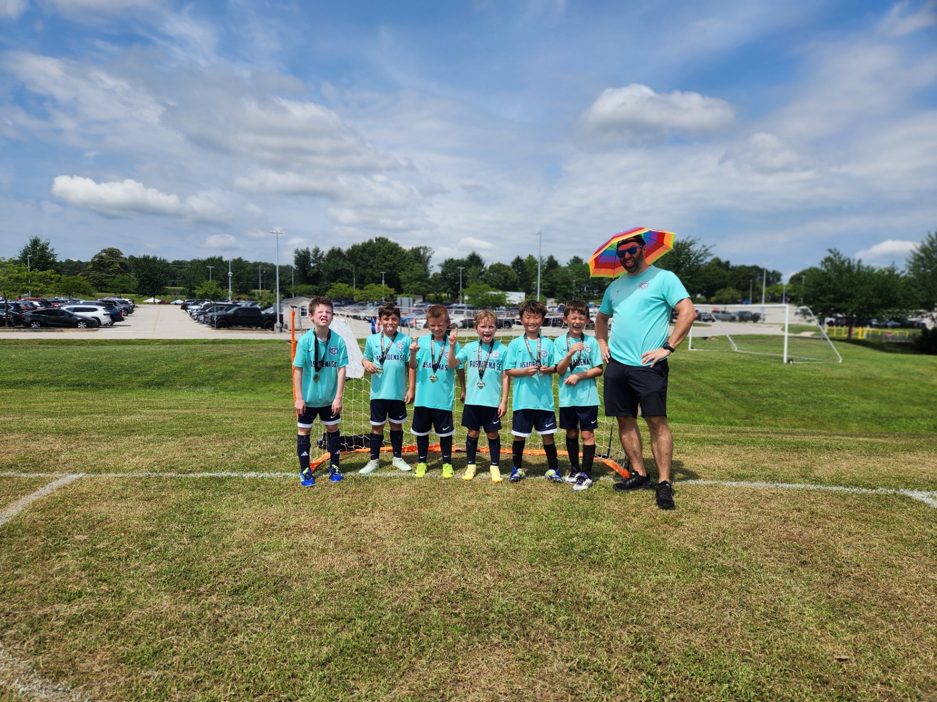 Pasadena SC boys team with medals after the championship