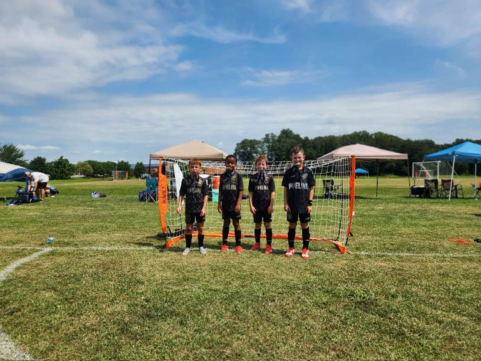 Pipeline team lined up in front of a goal before medal photos