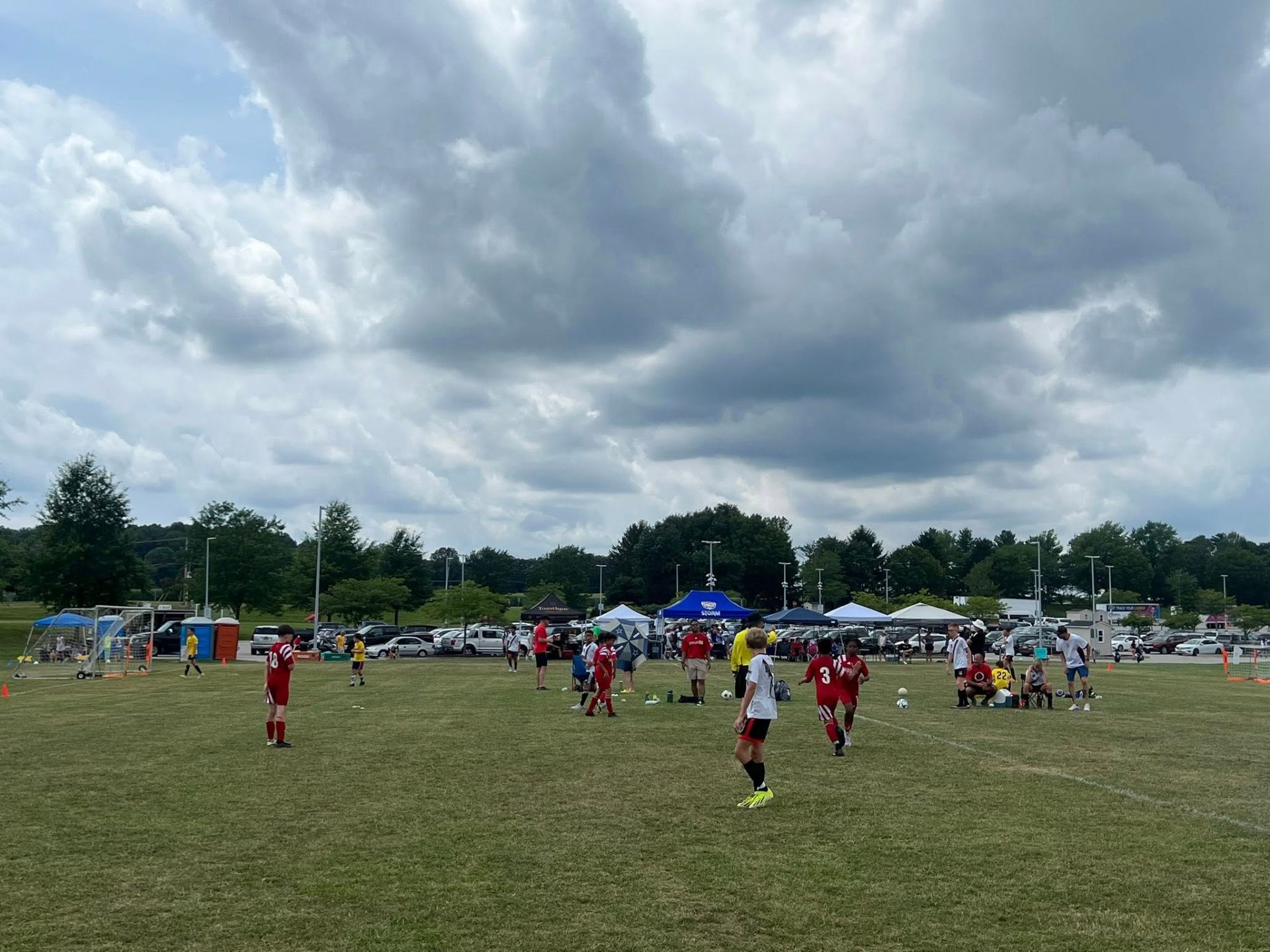 Tournament field under dramatic storm clouds