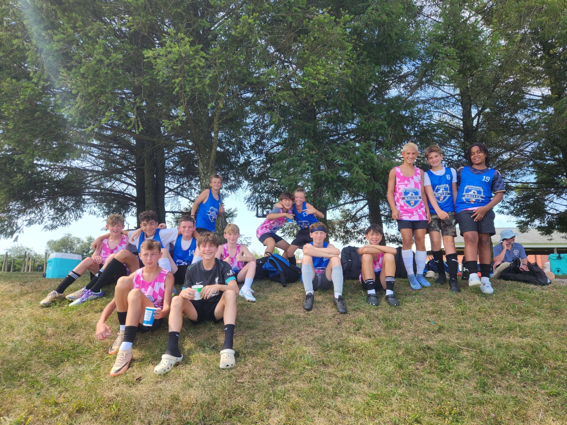 Tournament team celebrating together under the trees