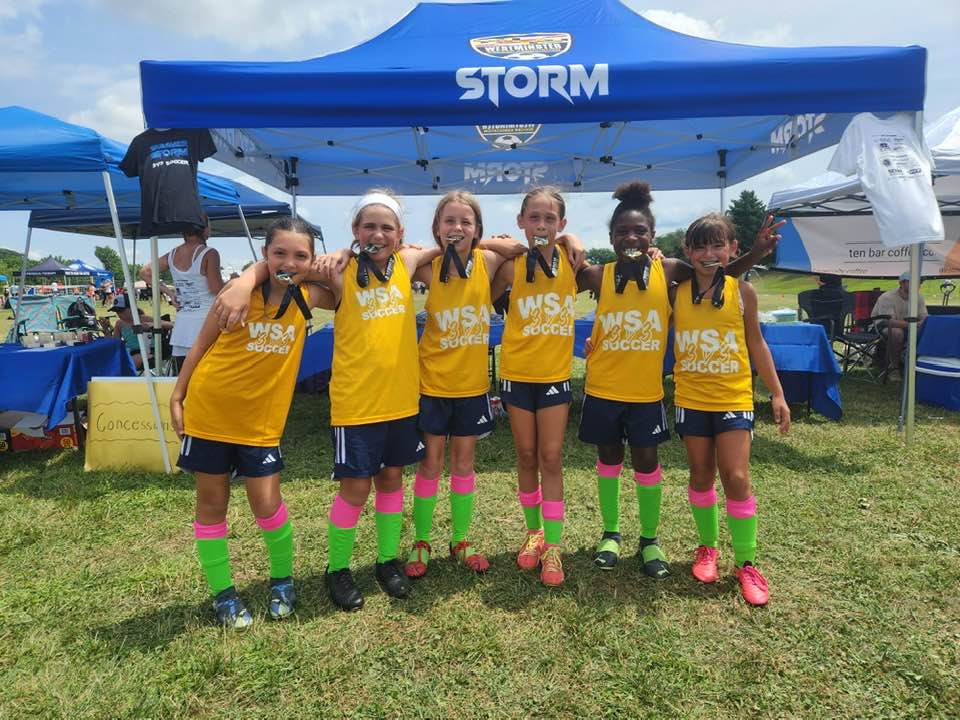 WSA girls team biting medals together